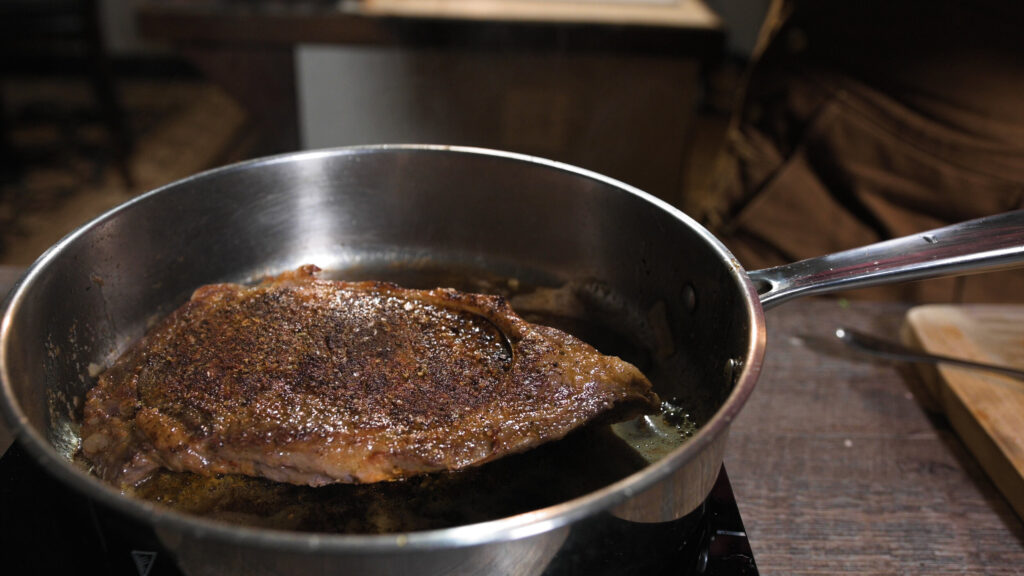 Ribeye is seared on all sides in a very hot pan